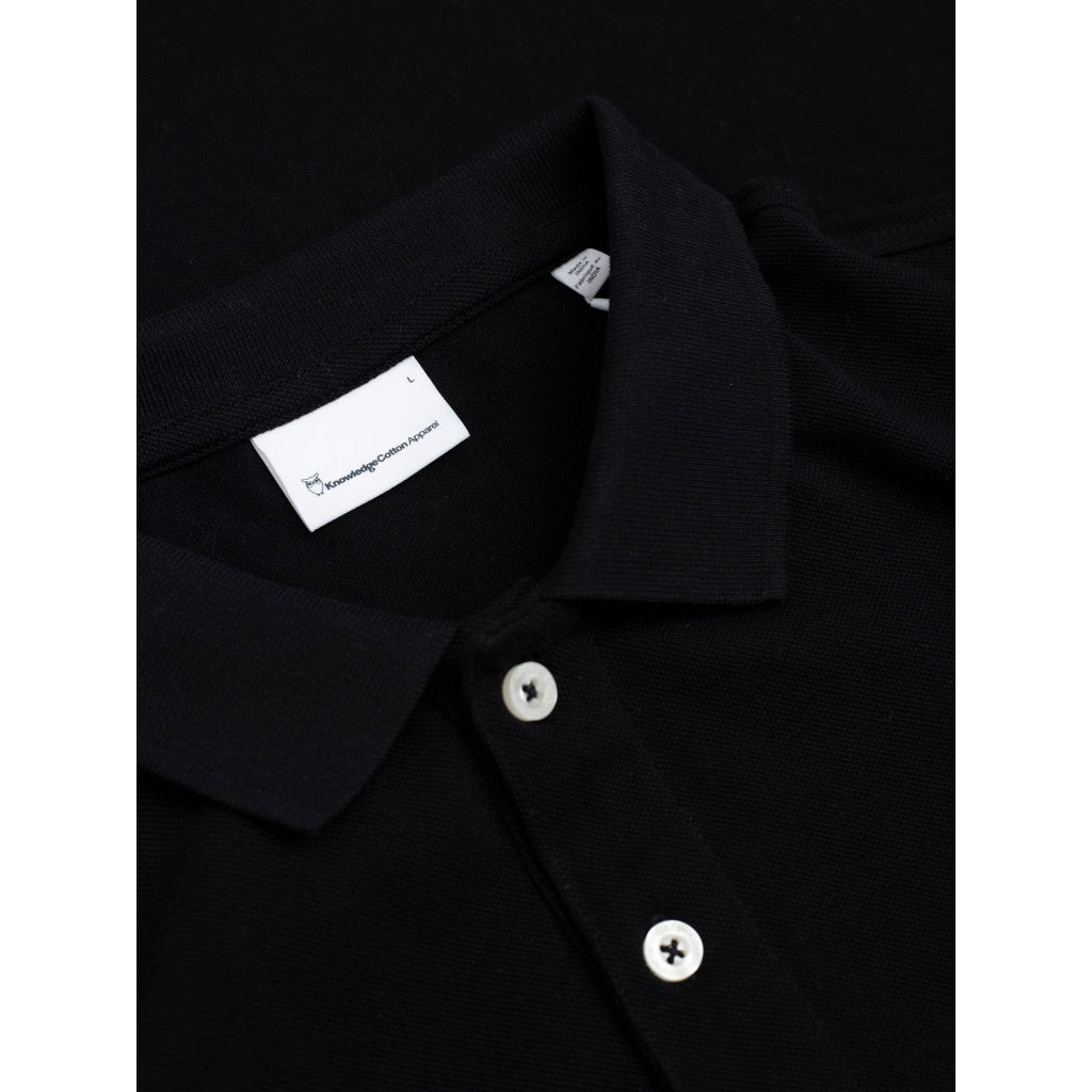 Polo brodé en coton bio | noir "toke basic badge polo black jet"